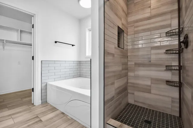 a bathroom with a bathtub and shower