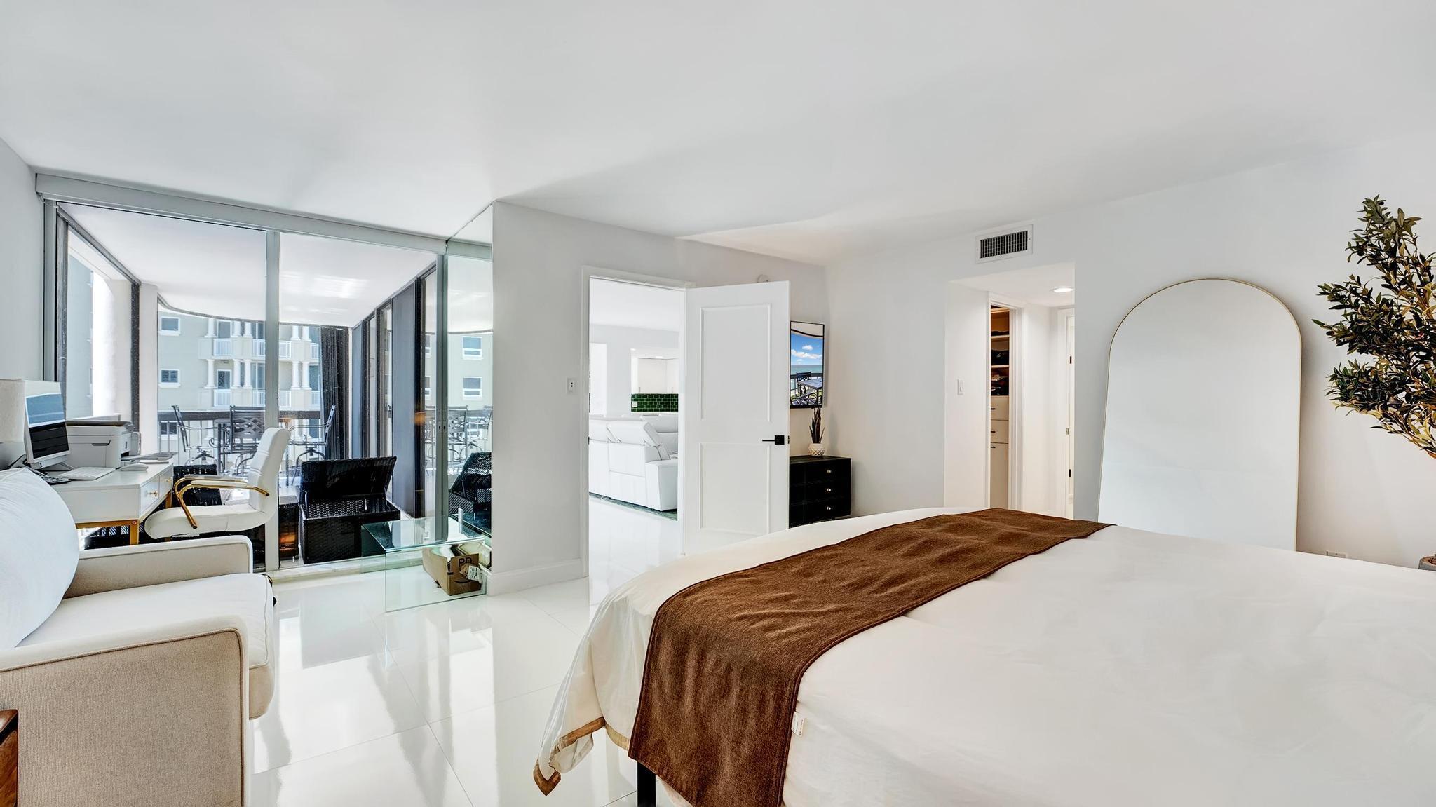5380 North Ocean Drive, Unit 6C Riviera Beach, FL 33404 - Photo 13 of 33 a bedroom with a bed a mirror and lamp