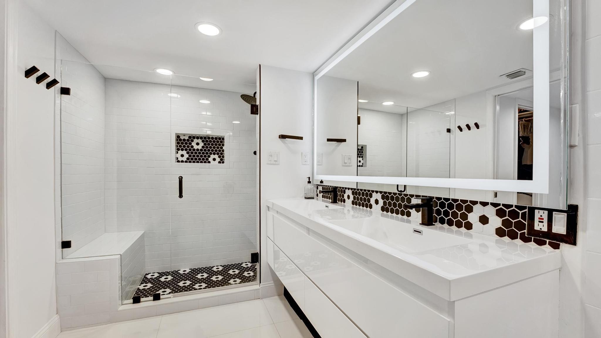 5380 North Ocean Drive, Unit 6C Riviera Beach, FL 33404 - Photo 16 of 33 a bathroom with a sink mirror and a shower