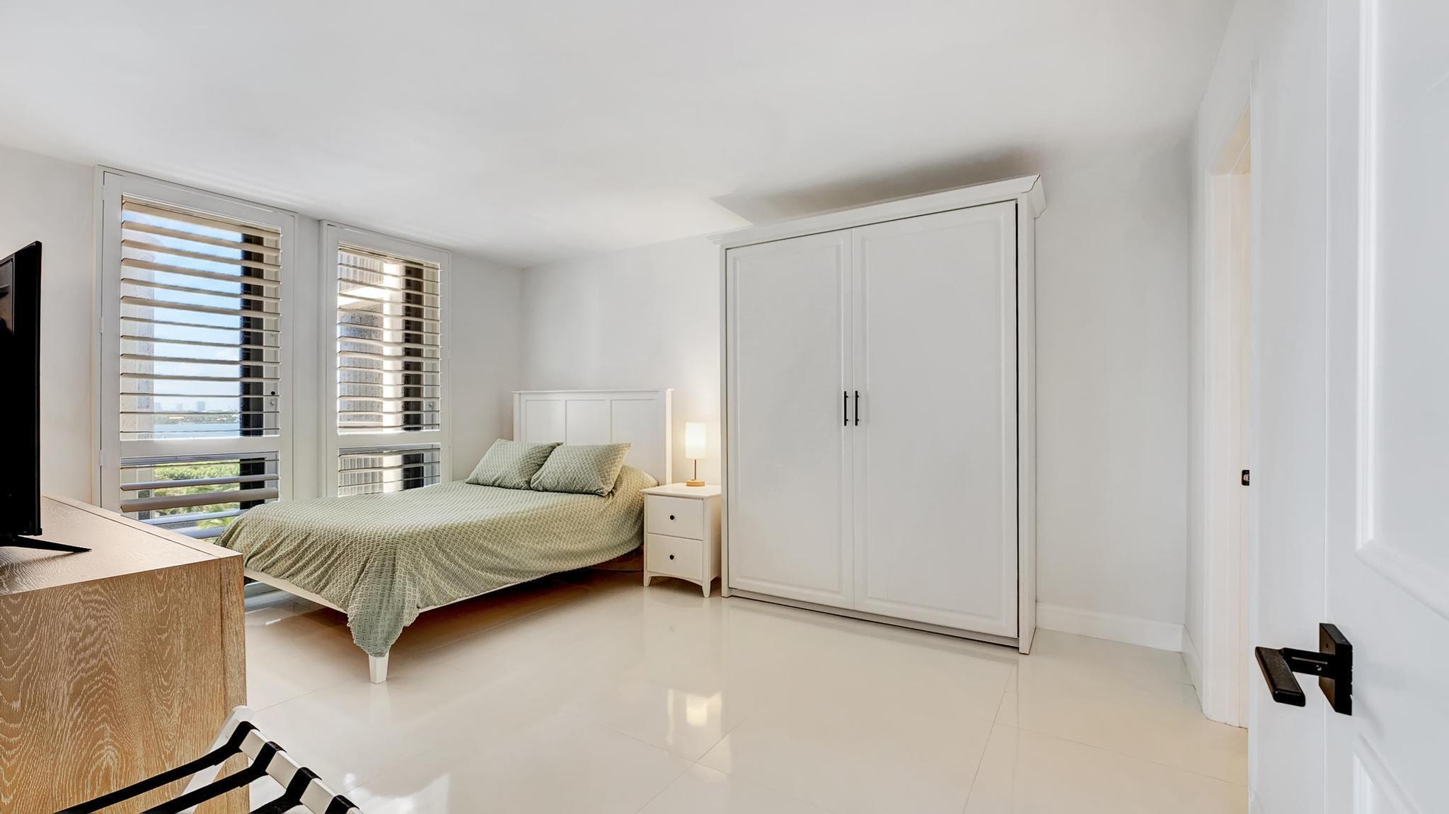 5380 North Ocean Drive, Unit 6C Riviera Beach, FL 33404 - Photo 18 of 33 a bedroom with a bed and a window