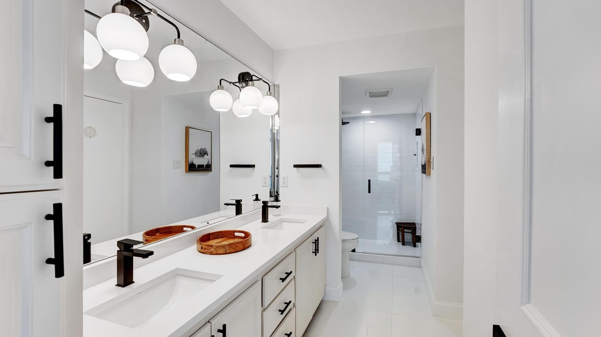 5380 North Ocean Drive, Unit 6C Riviera Beach, FL 33404 - Photo 19 of 33 a bathroom with a sink a tub and mirror