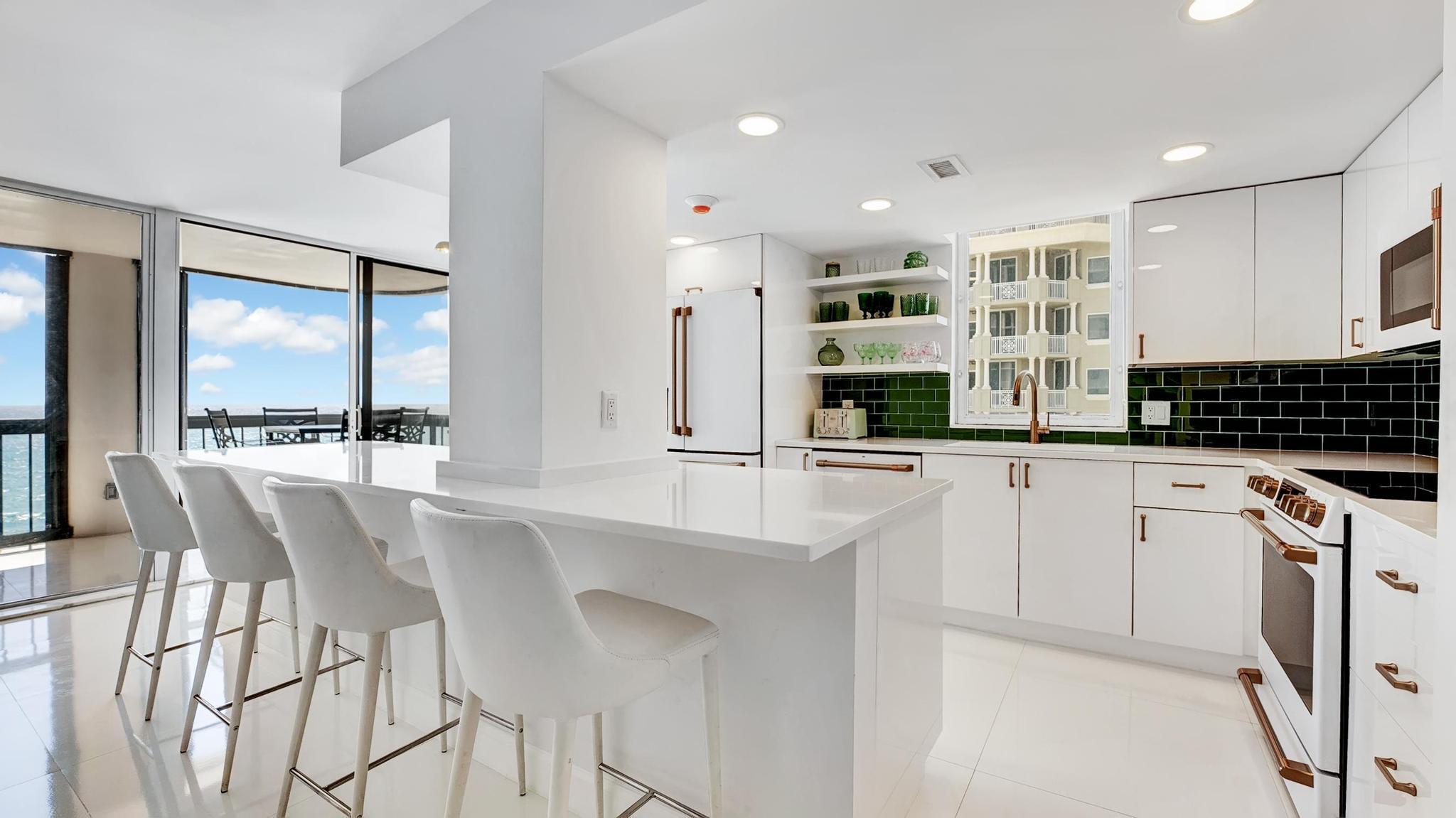 5380 North Ocean Drive, Unit 6C Riviera Beach, FL 33404 - Photo 5 of 33 a kitchen with stainless steel appliances kitchen island granite countertop a stove a sink and a refrigerator
