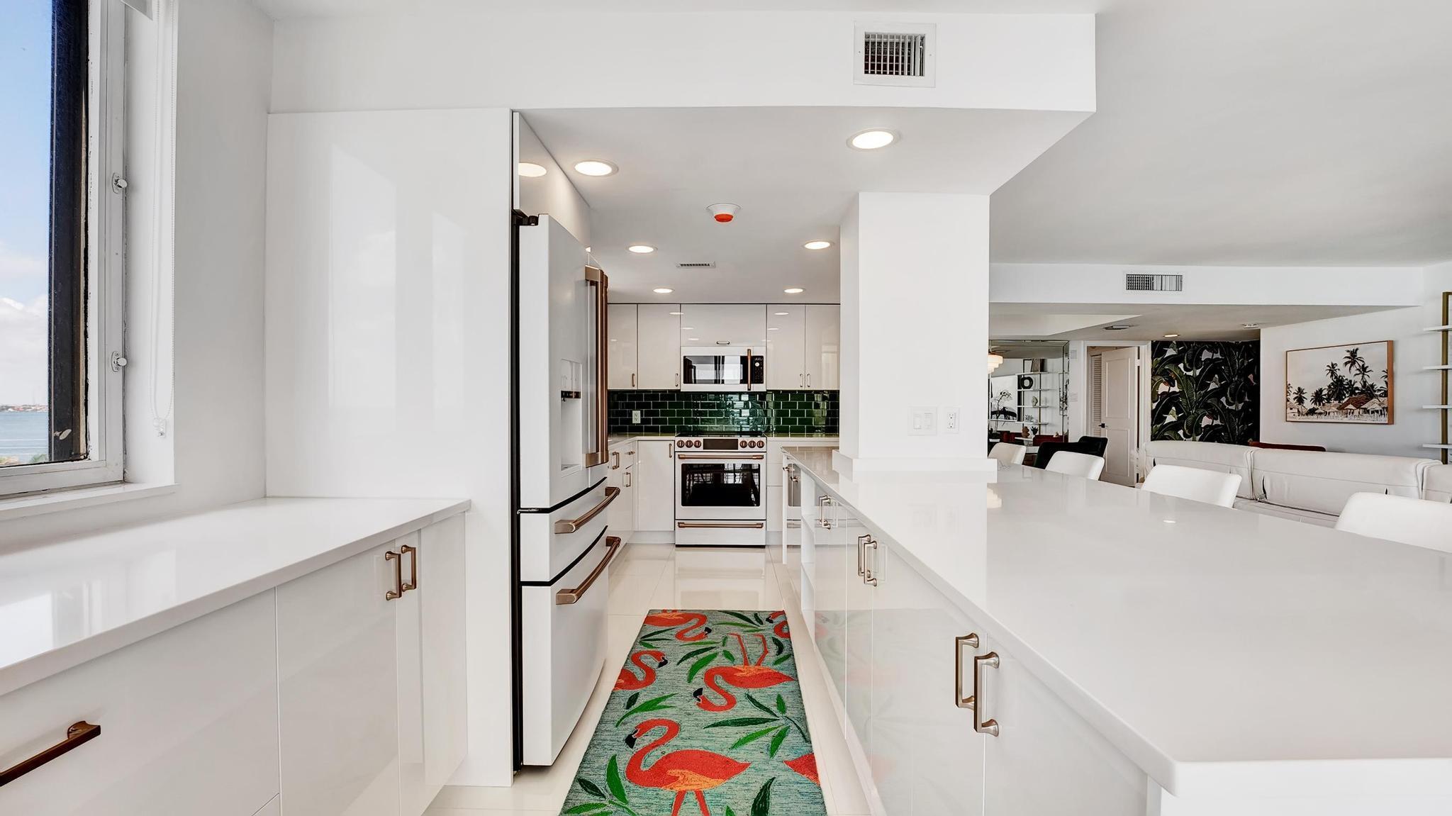 5380 North Ocean Drive, Unit 6C Riviera Beach, FL 33404 - Photo 7 of 33 a large white kitchen with stainless steel appliances