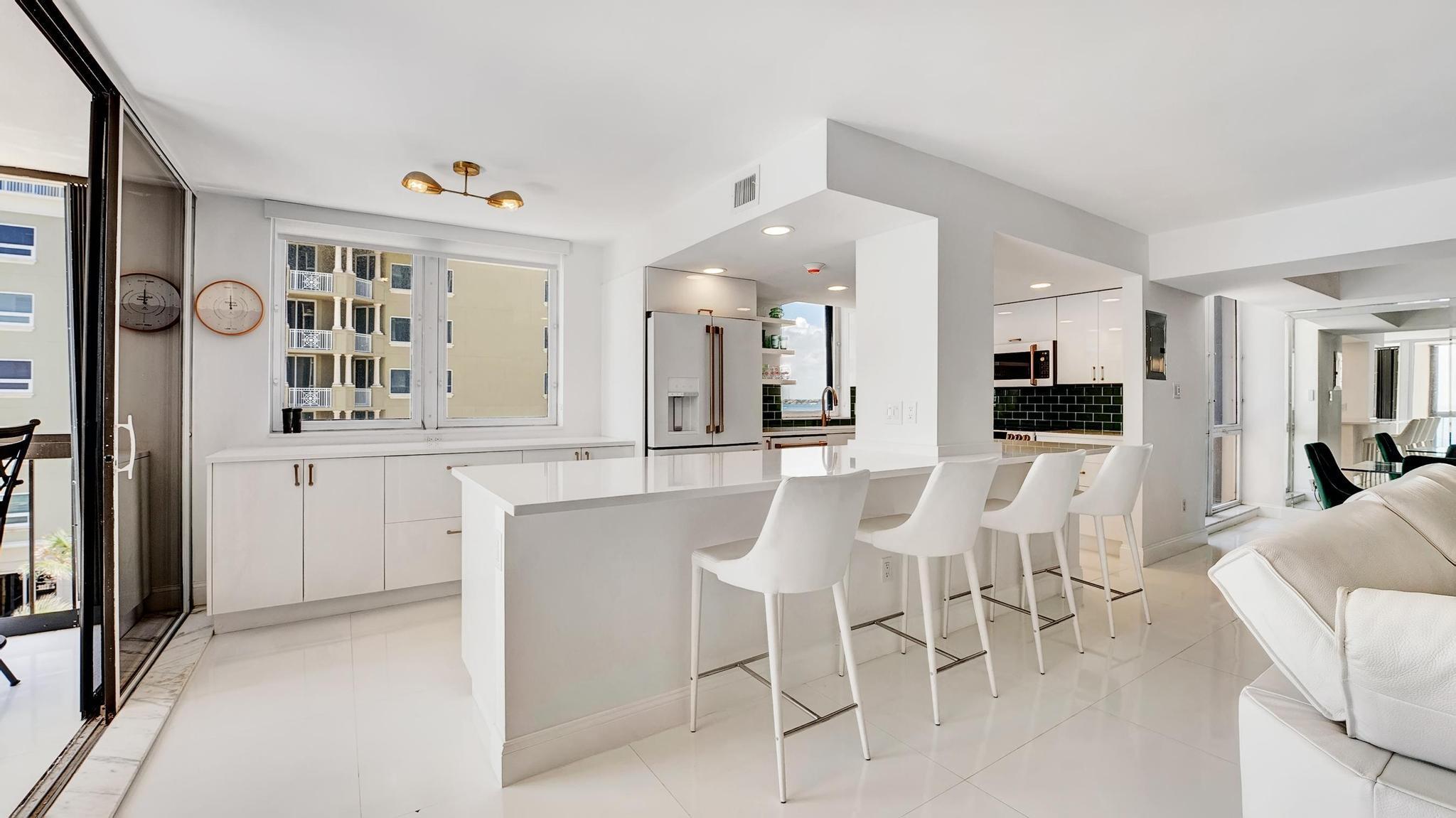 5380 North Ocean Drive, Unit 6C Riviera Beach, FL 33404 - Photo 10 of 33 a dining hall with stainless steel appliances kitchen island granite countertop a dining table and chairs