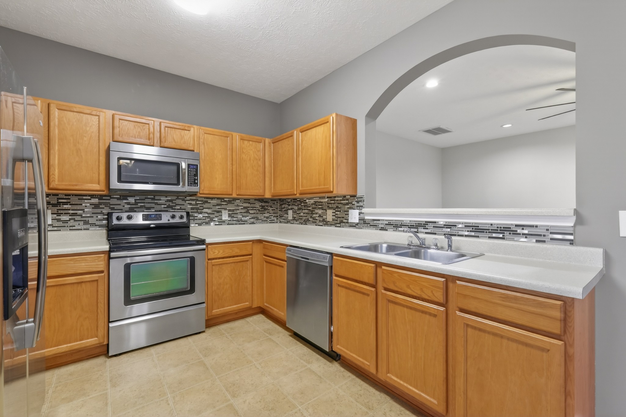 8333 Rossi Road Brentwood, TN 37027 - Photo 9 of 20 a kitchen with stainless steel appliances granite countertop a stove a sink and a microwave