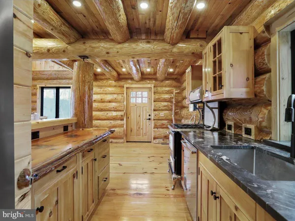 a kitchen with stainless steel appliances granite countertop a sink and stove