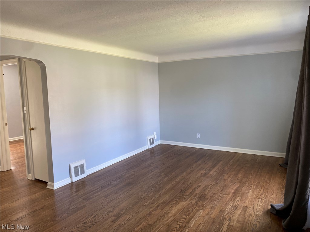 5680 Shawnee Road Cleveland, OH 44124 - Photo 9 of 21 Unfurnished room with dark hardwood floors