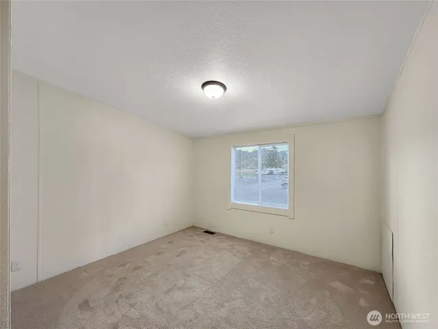 an empty room with a empty space and windows