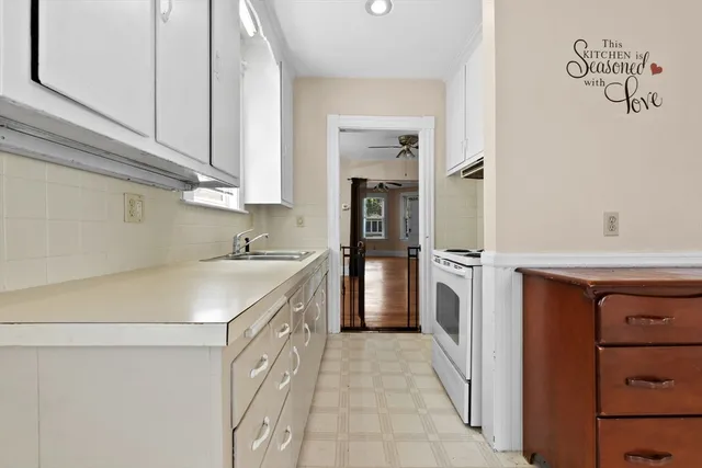 a utility room with cabinets washer and dryer