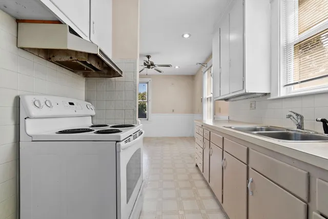 a kitchen with stainless steel appliances granite countertop a sink and a stove