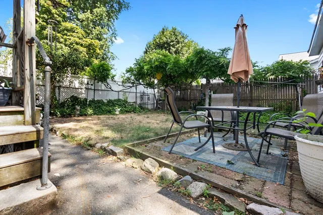 a view of a sitting area with furniture in backyard