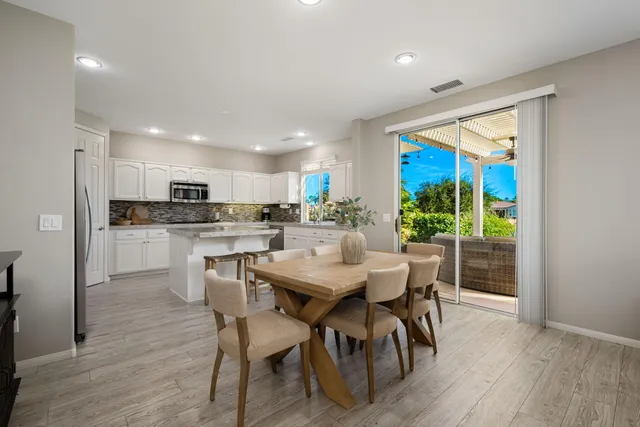 a bathroom with a double vanity sink a mirror and a bathtub