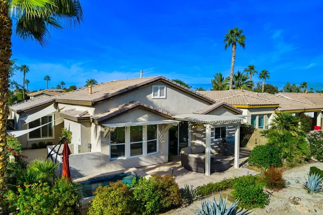 a view of a chair and tables in the patio