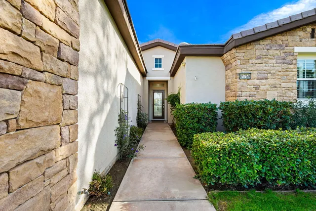 a living room with furniture a fireplace and a large window