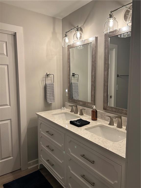 131 Fox Place Canton, GA 30114 - Photo 11 of 29 a bathroom with a double vanity sink and a mirror