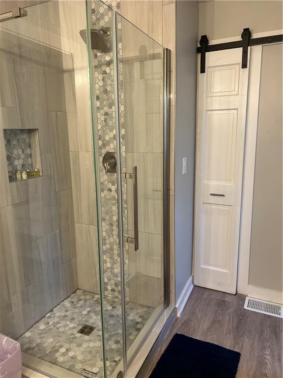 131 Fox Place Canton, GA 30114 - Photo 12 of 29 a bathroom with a shower and a glass door