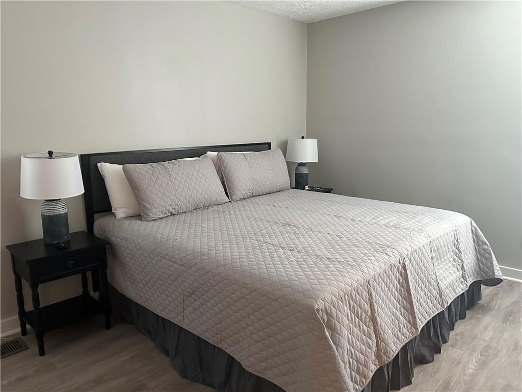 131 Fox Place Canton, GA 30114 - Photo 14 of 29 a large bed sitting in a bedroom next to a lamp