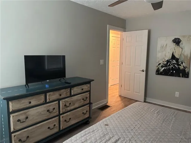 a bathroom with a sink a toilet and a window