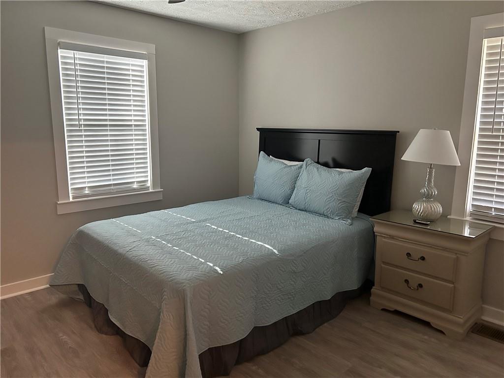 131 Fox Place Canton, GA 30114 - Photo 18 of 29 a bedroom with a bed and a lamp