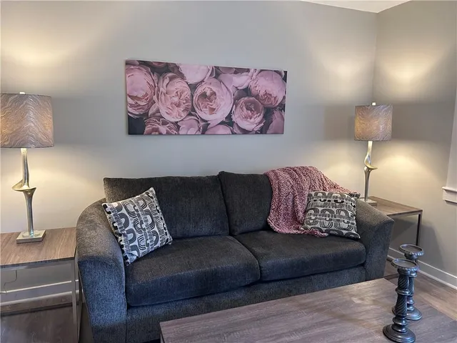 a living room with furniture and a lamp
