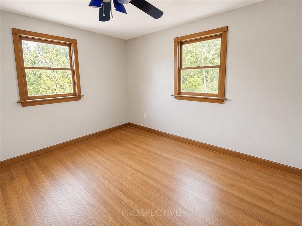 3079 Mt Troy Road Pittsburgh, PA 15212 - Photo 13 of 30 a view of an empty room with wooden floor and a window