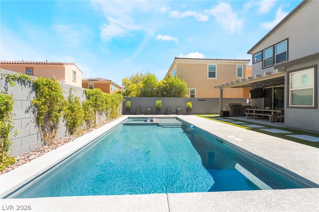 2166 Trivero Street Henderson, NV 89044 - Photo 38 of 61 An inviting backyard oasis offers a sparkling in-ground pool and dedicated barbecue area.