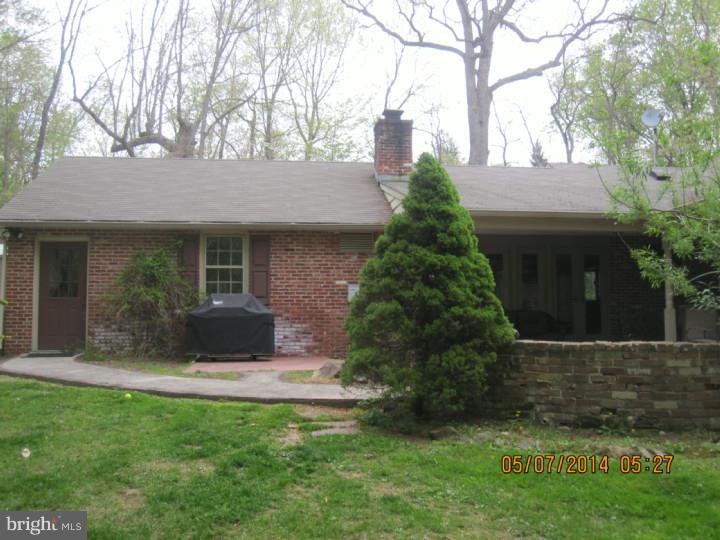 3574 Glenway Road Huntingdon Valley, PA 19006 - Photo 3 of 12 a front view of a house with a yard and garage