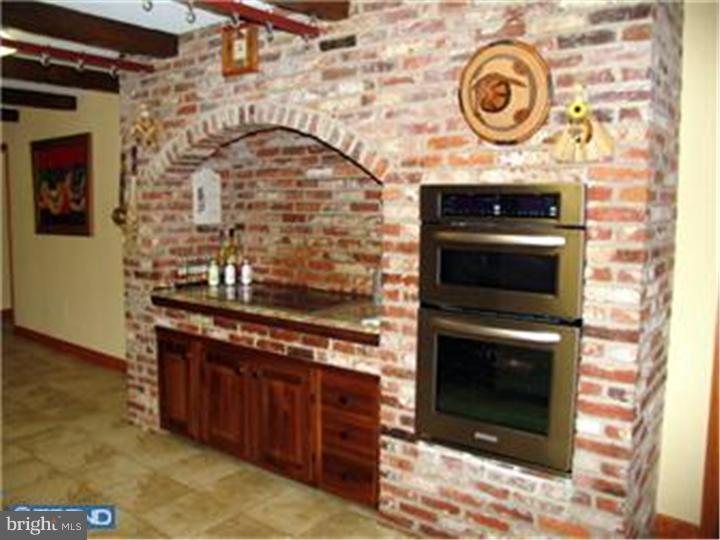3574 Glenway Road Huntingdon Valley, PA 19006 - Photo 7 of 12 a kitchen with a stove and a microwave