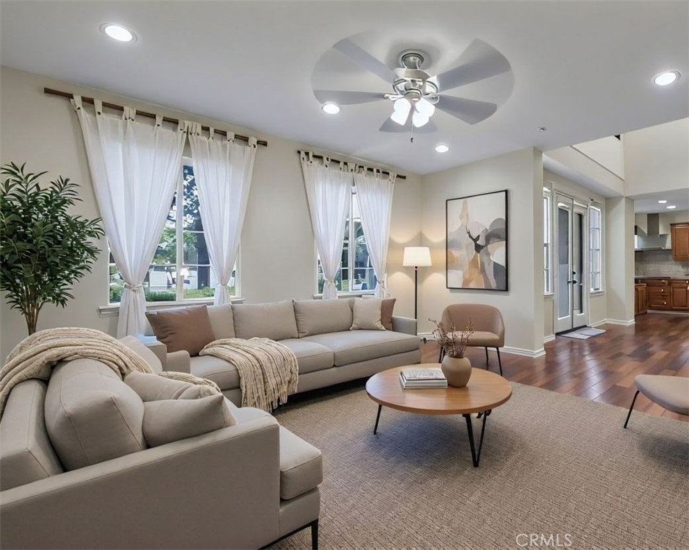a living room with furniture a chandelier and a rug