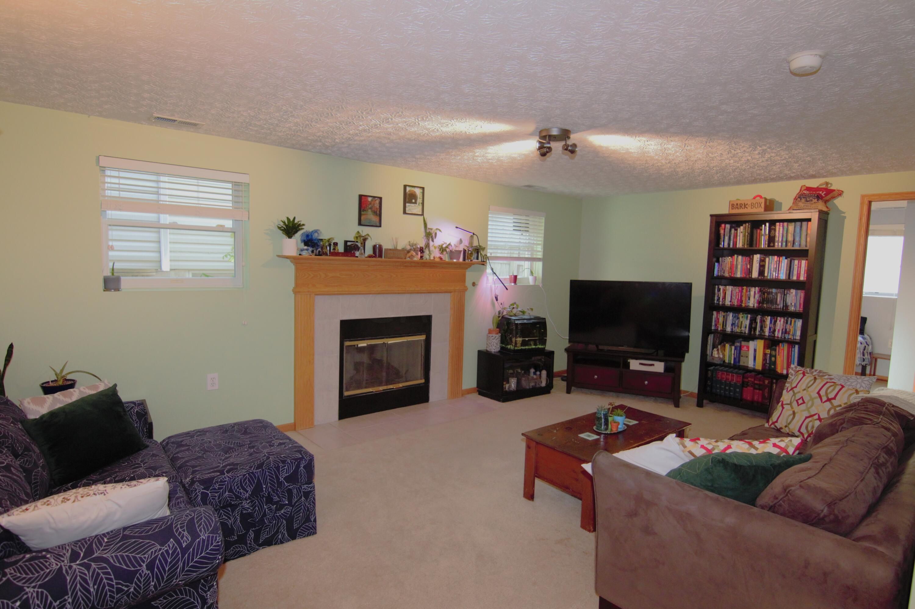 4571 Nickerson Road Columbus, OH 43228 - Photo 26 of 37 A view of the living room with bedroom #4 straight ahead on the right. The door to the right of bedroom #4 is the laundry room.