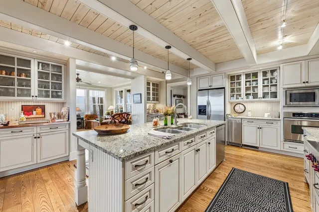 a kitchen with stainless steel appliances granite countertop a stove and cabinets