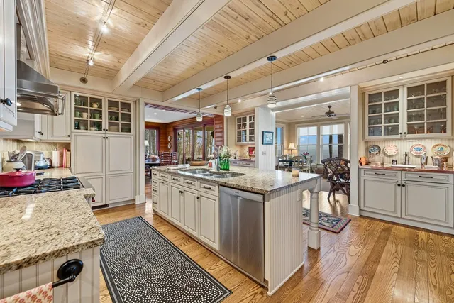 a living room with furniture ceiling fan and a large window