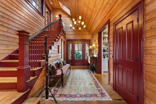 a living room with furniture a fireplace and large windows
