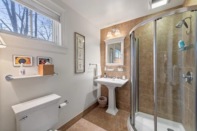 a bathroom with a painting on the wall and a shower