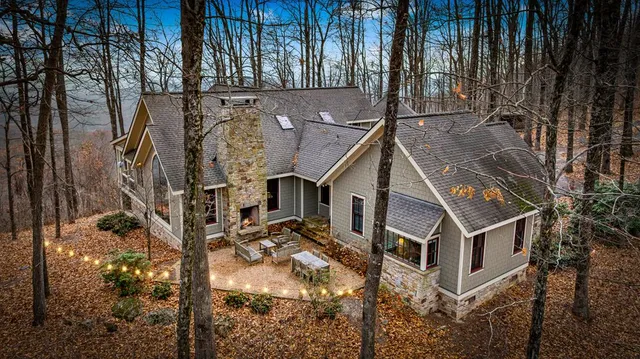 a aerial view of a house with a yard and balcony