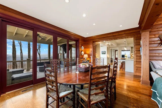a dining room with furniture and wooden floor
