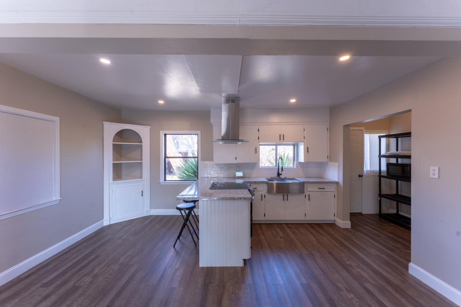 963 North Arthur Avenue Fresno, CA 93728 - Photo 12 of 26 a kitchen with a wooden floor and cabinets