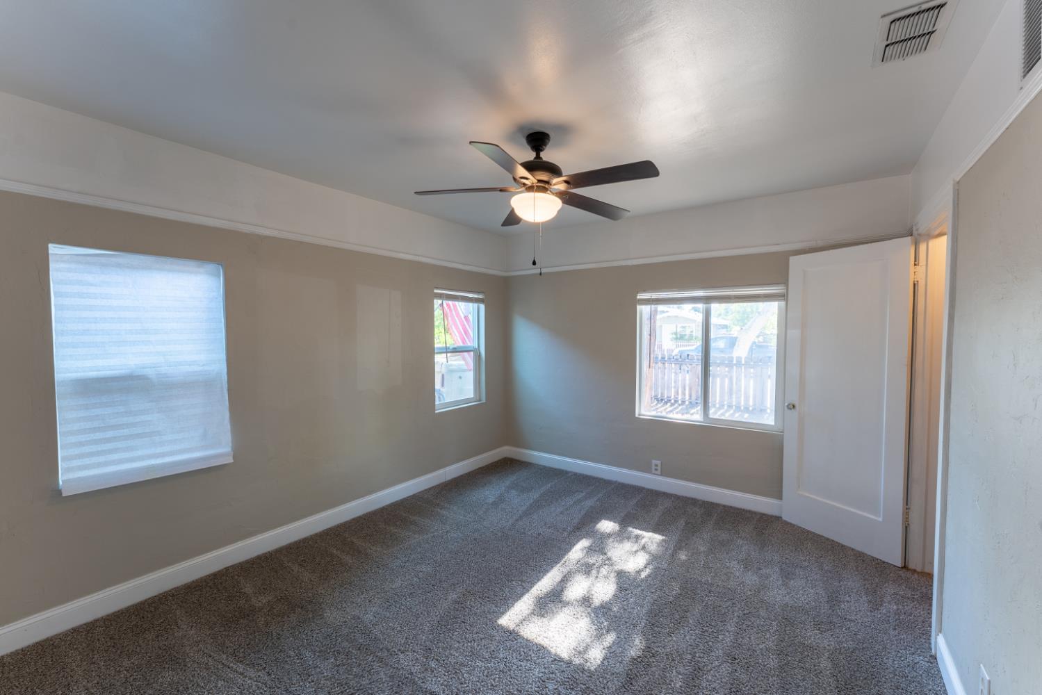 963 North Arthur Avenue Fresno, CA 93728 - Photo 18 of 26 a view of a room with window and ceiling fan