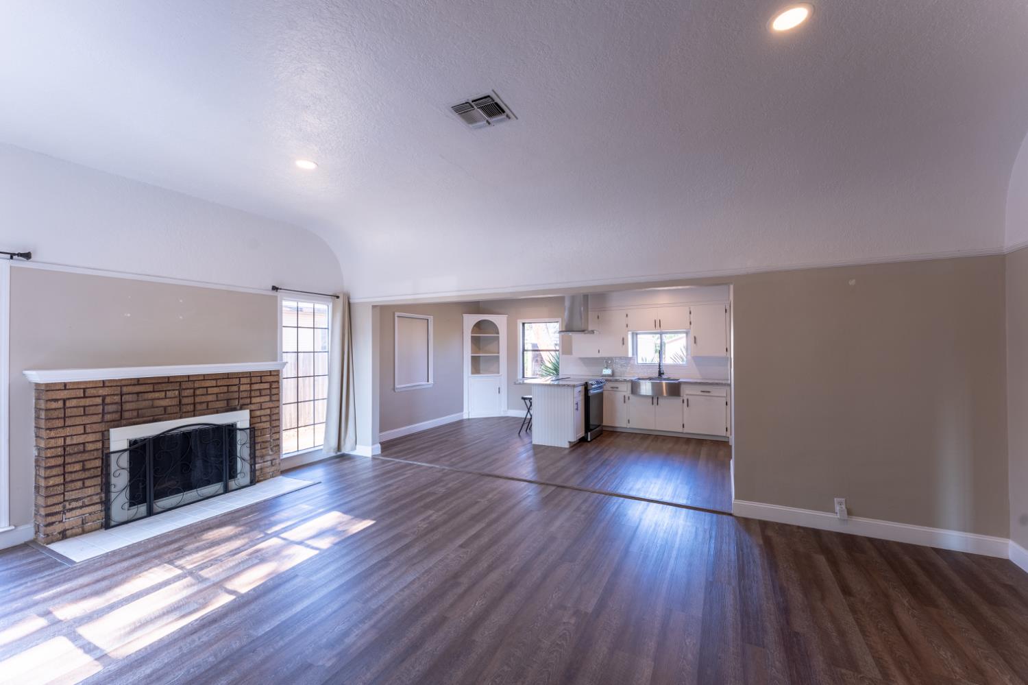 963 North Arthur Avenue Fresno, CA 93728 - Photo 9 of 26 a view of a livingroom with wooden floor and a fireplace