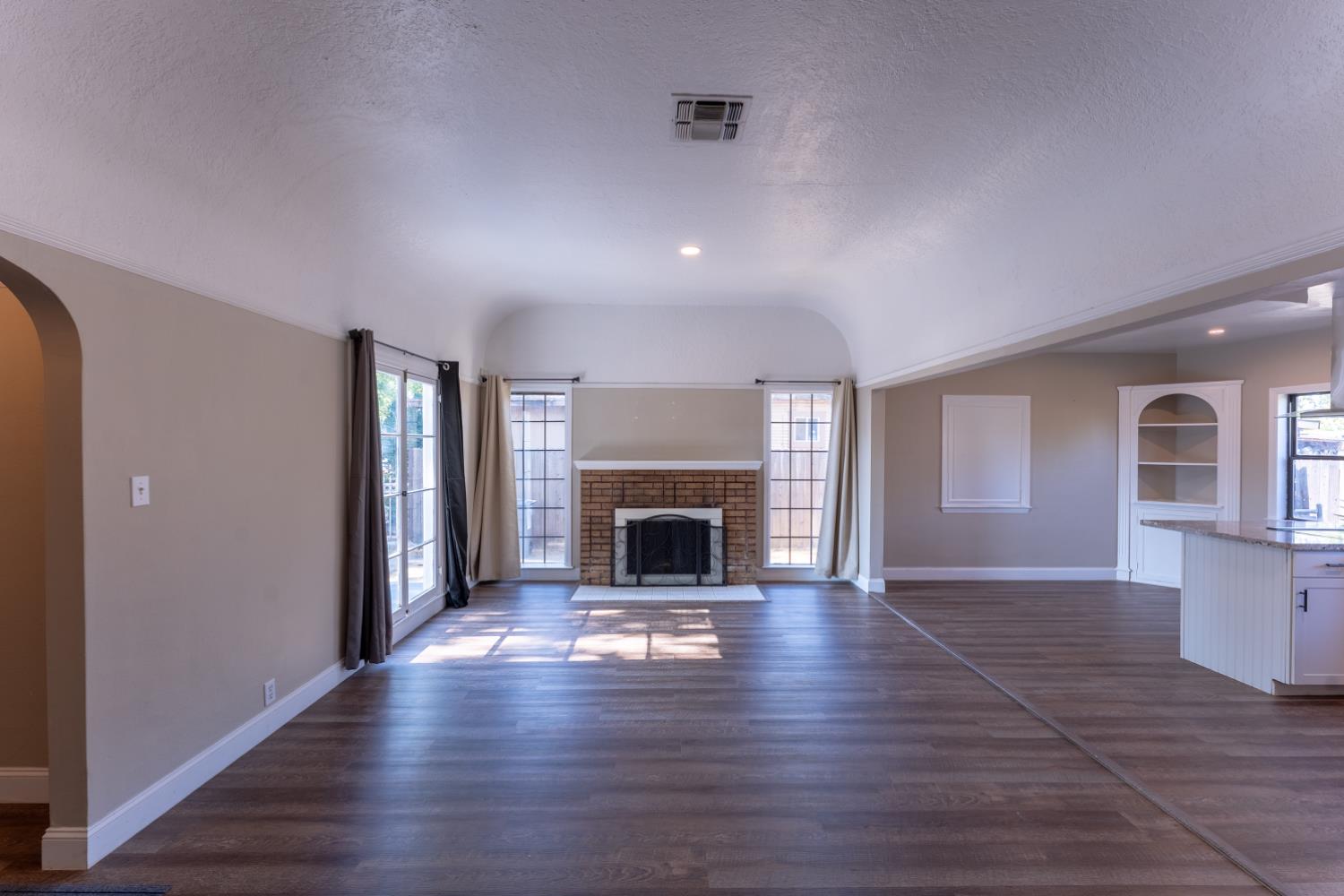 963 North Arthur Avenue Fresno, CA 93728 - Photo 10 of 26 wooden floor fireplace and windows in an empty room
