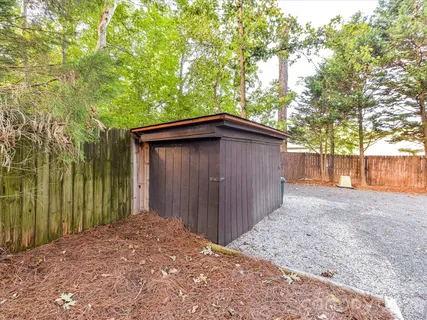 a backyard of a house with plants and tree