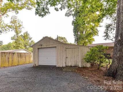 a wooden house with trees in front of it