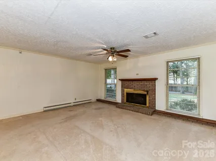 a view of an empty room with a fireplace