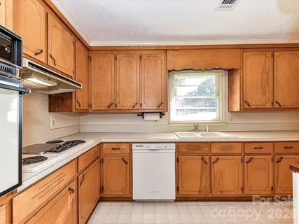 a kitchen with stainless steel appliances granite countertop a sink and a stove