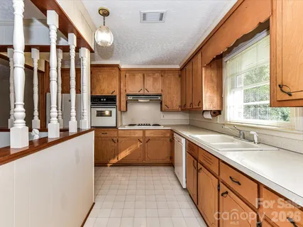 a kitchen with stainless steel appliances granite countertop a sink and cabinets