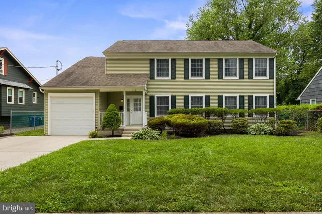 a front view of a house with a yard and porch