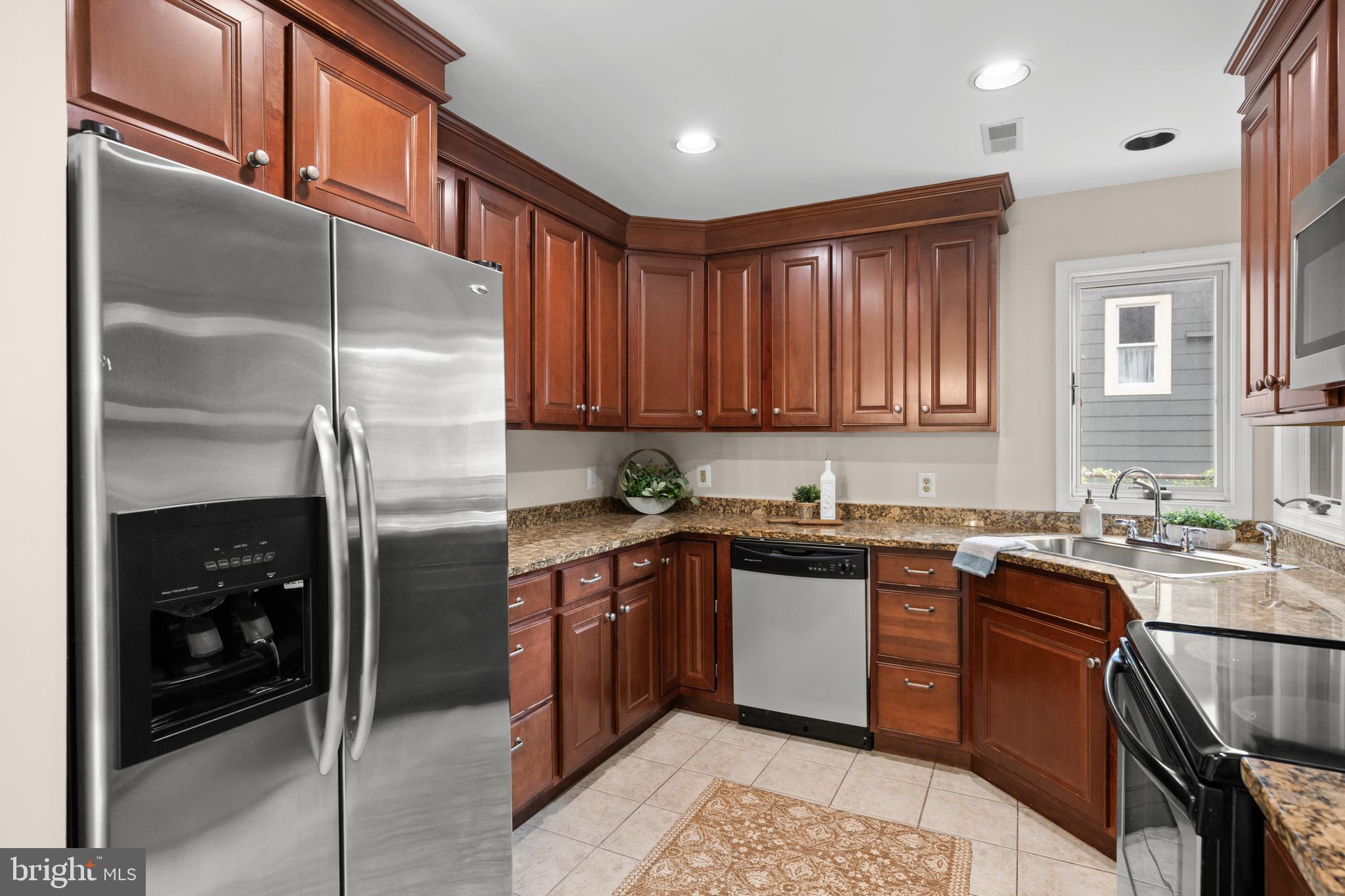 310 South Washington Avenue Moorestown, NJ 08057 - Photo 11 of 37 a kitchen with stainless steel appliances granite countertop a refrigerator a sink and wooden cabinets