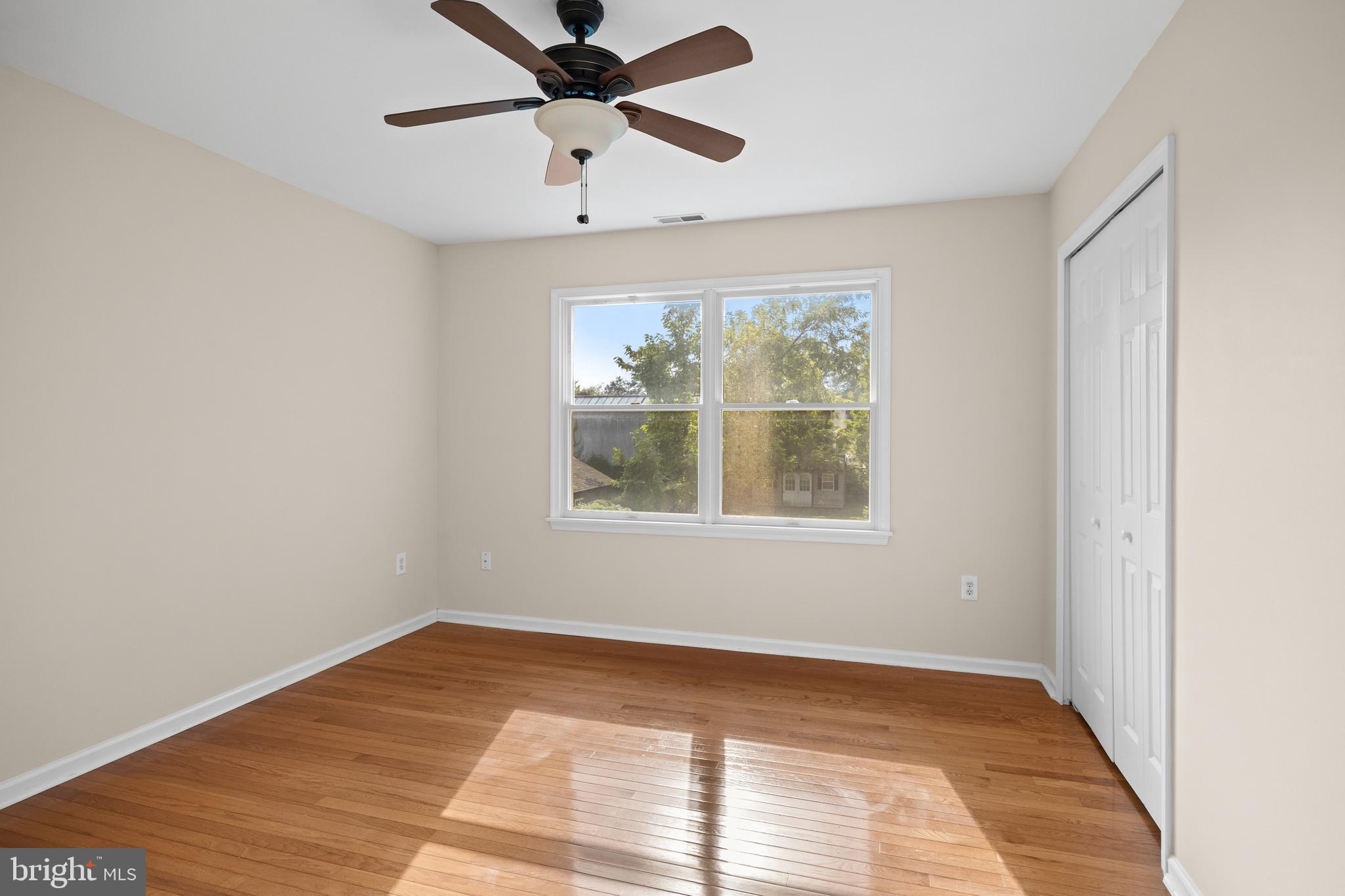 310 South Washington Avenue Moorestown, NJ 08057 - Photo 27 of 37 an empty room with wooden floor chandelier and windows