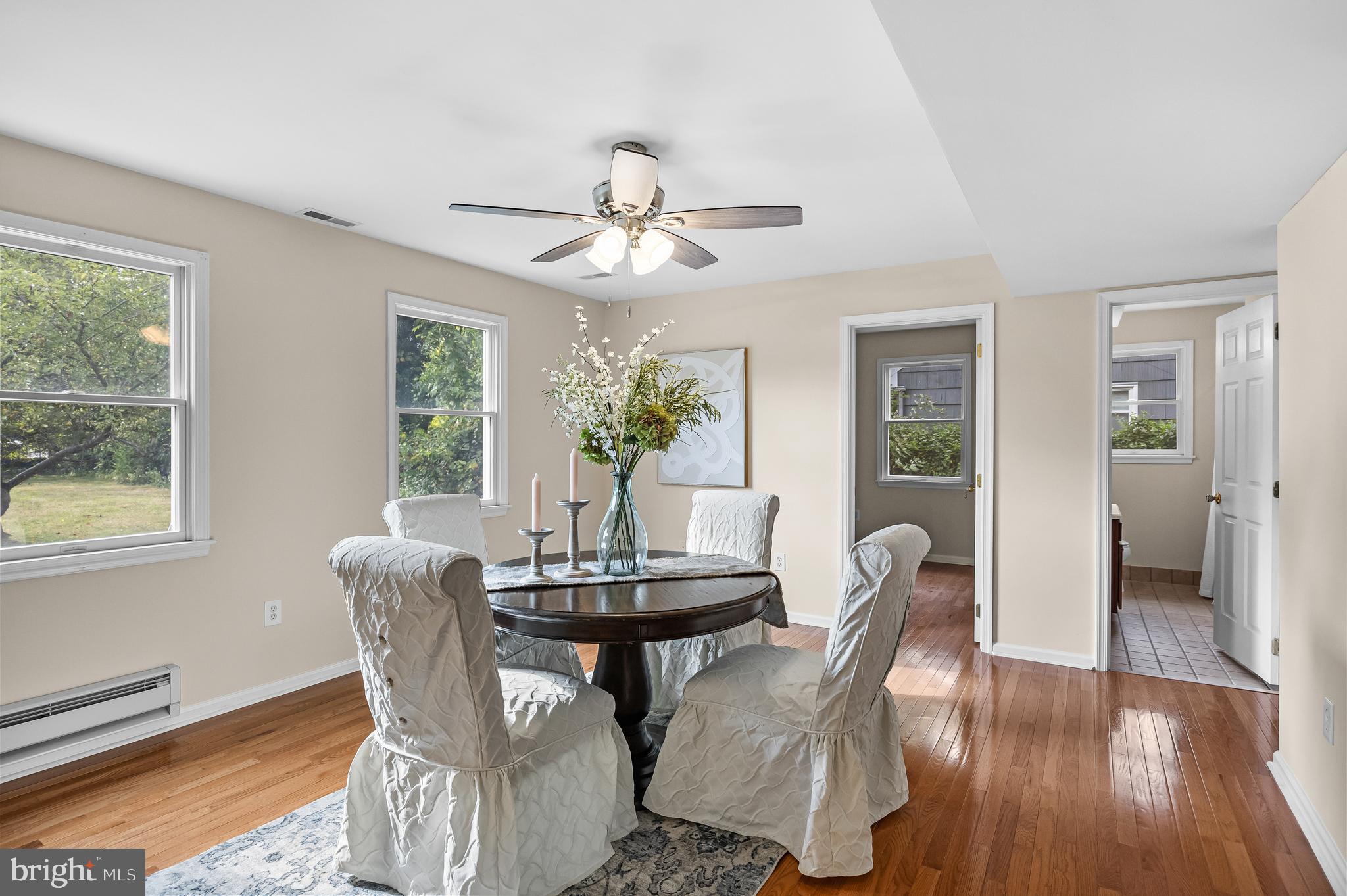 310 South Washington Avenue Moorestown, NJ 08057 - Photo 8 of 37 a dining room with furniture potted plants and wooden floor