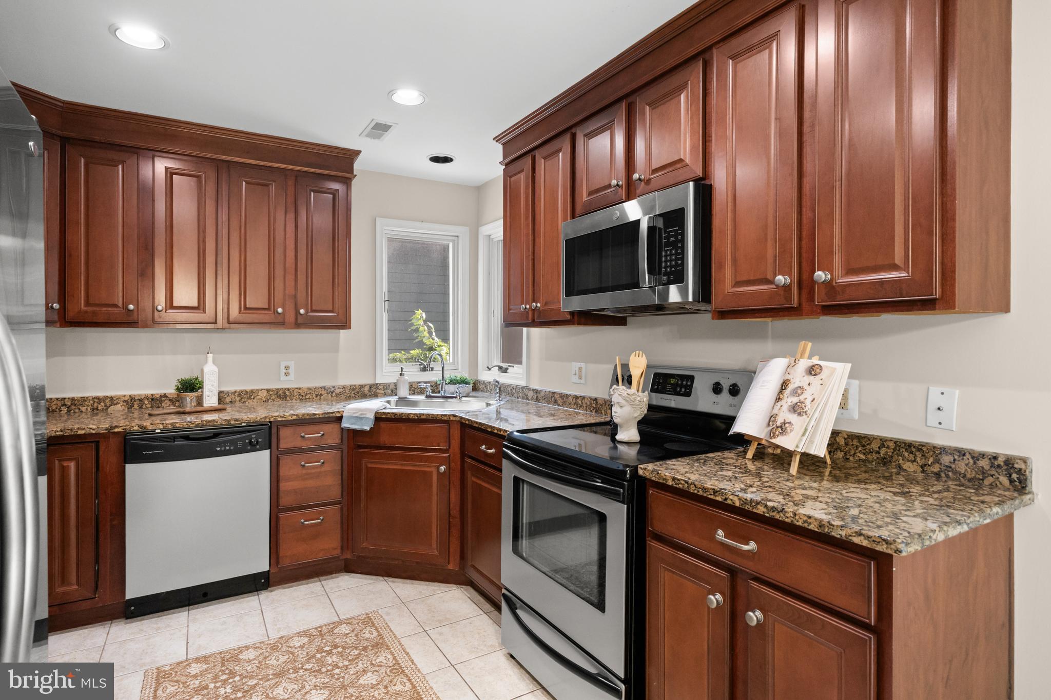 310 South Washington Avenue Moorestown, NJ 08057 - Photo 10 of 37 a kitchen with granite countertop stainless steel appliances stove microwave refrigerator and sink